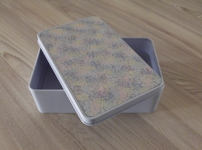 Storage tin with mottled pastel lid